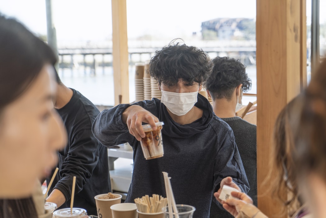 man in mask in cafe, pandemic shaming